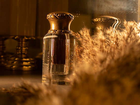 Perfume bottle with decorative cap on a reflective surface with blurred background
