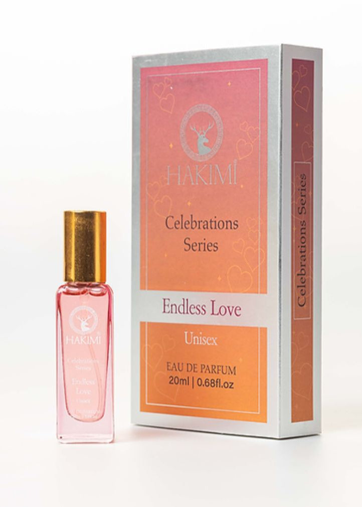 Pink perfume bottle with gold cap next to its packaging on a white background