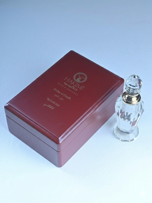 Red box with a clear glass bottle featuring gold accents on a light blue background