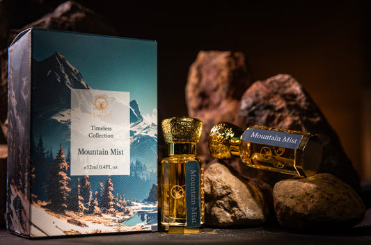 Perfume bottles labeled 'Mountain Mist' with packaging featuring mountain scenery on a dark background.