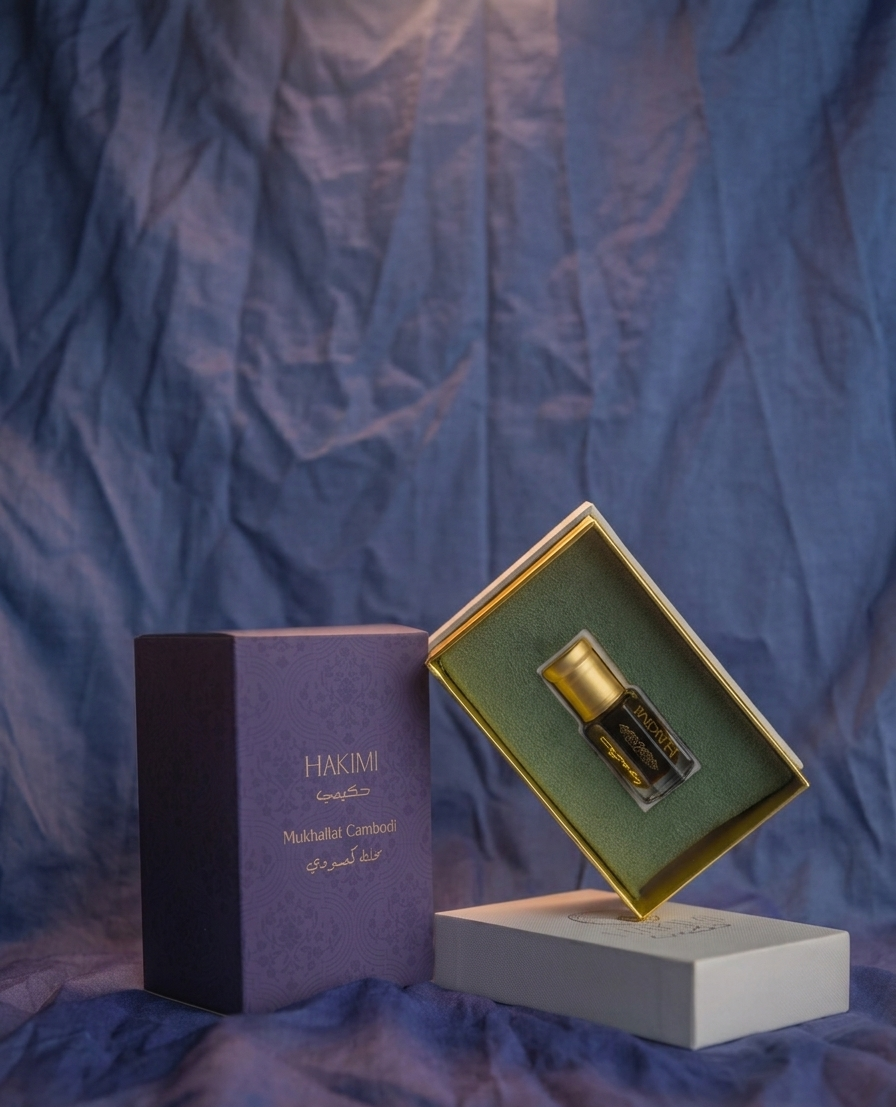 Perfume bottle and packaging on a textured blue surface