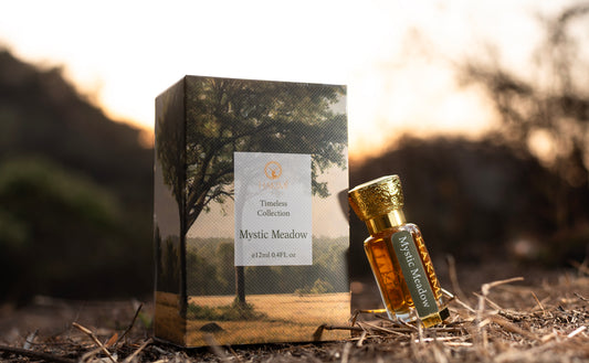 Perfume bottle and packaging with 'Mystic Meadow' label on a natural background