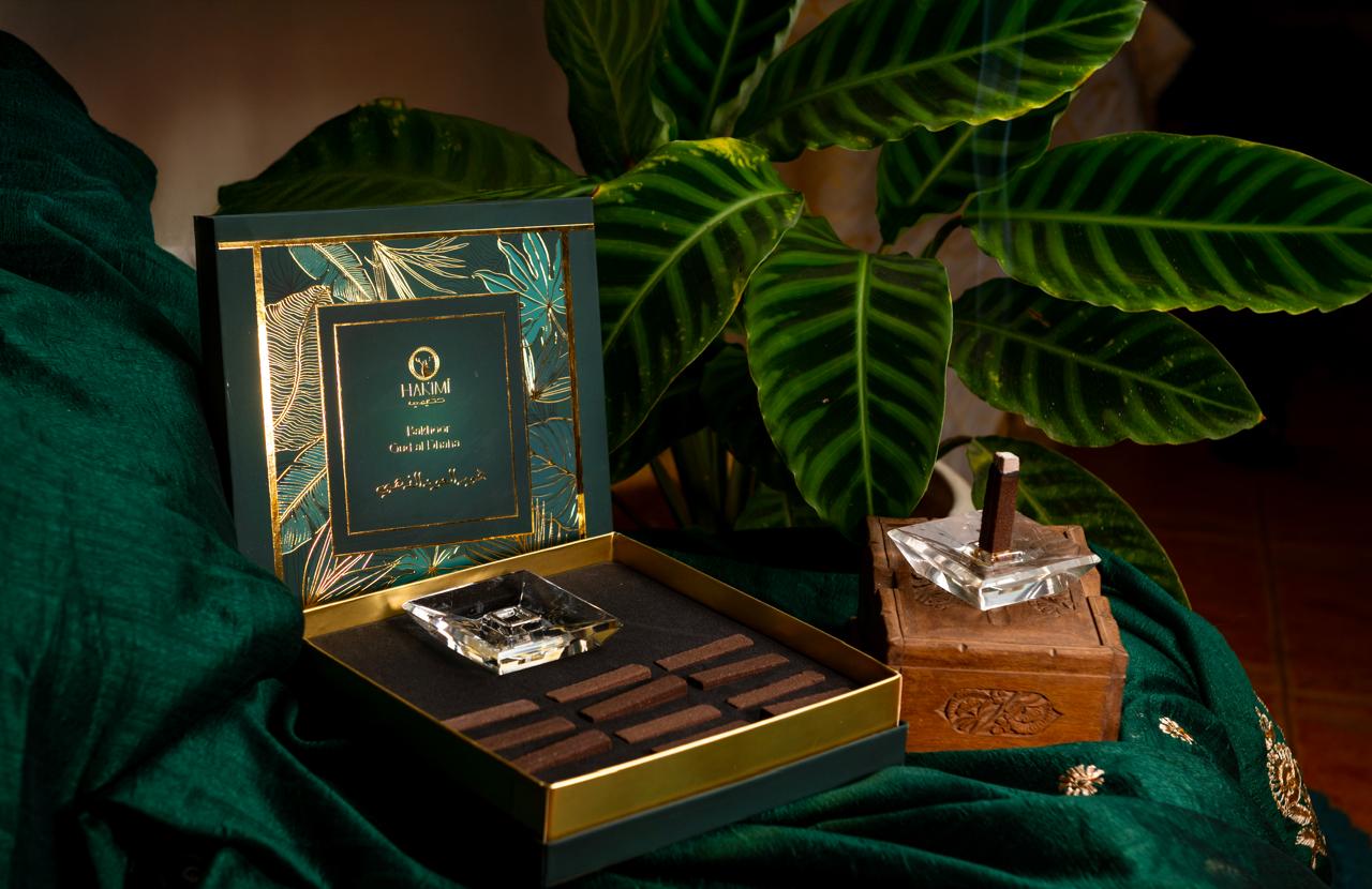 Luxury chocolate set with a decorative box on a green fabric background