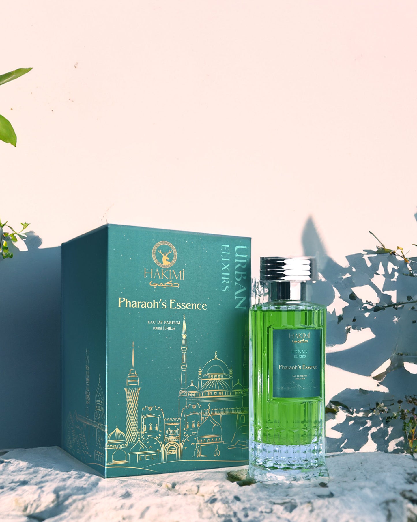 Perfume bottle and packaging with 'Pharaoh's Essence' branding on a decorative background.