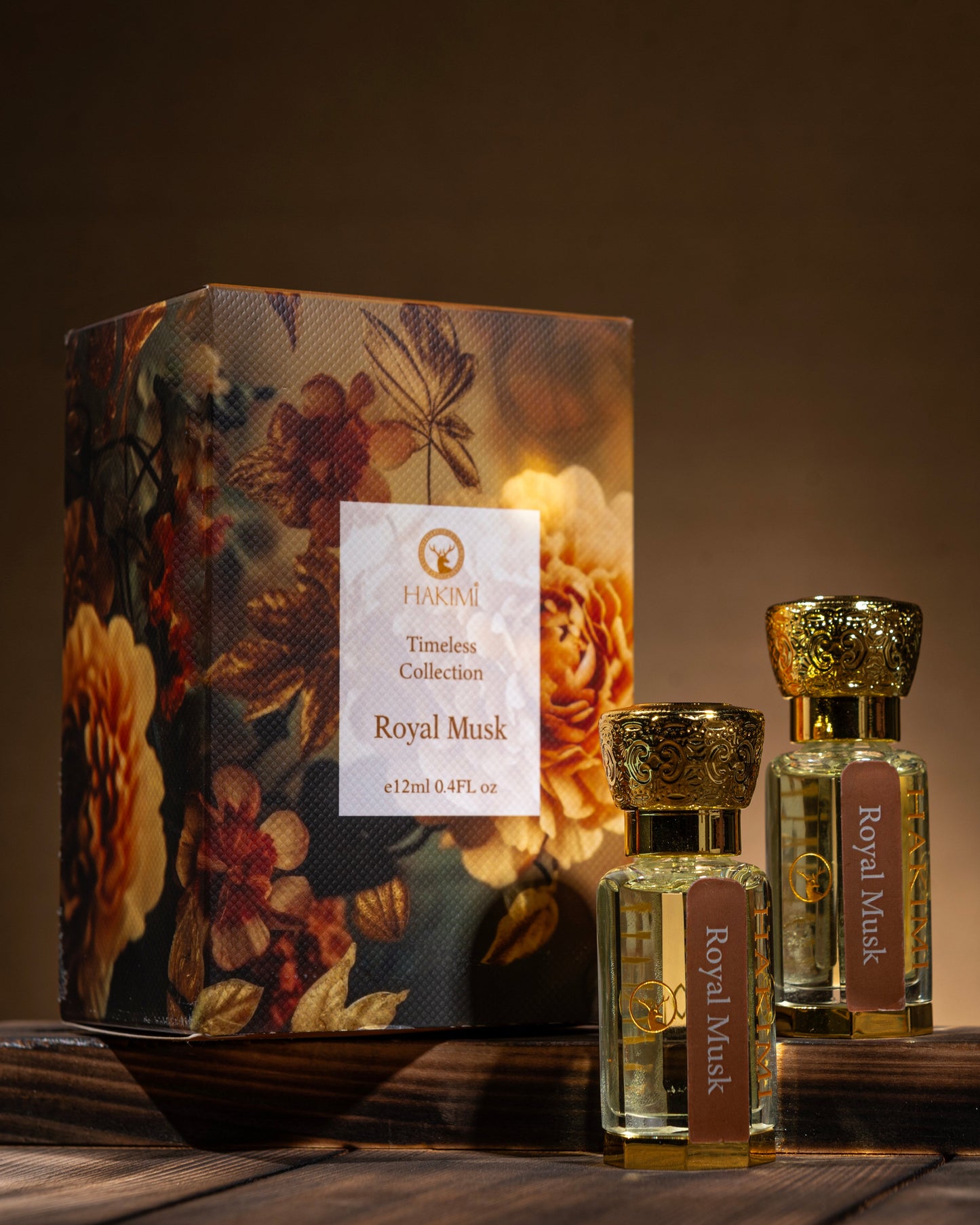 Two perfume bottles with a decorative box on a wooden surface against a dark background