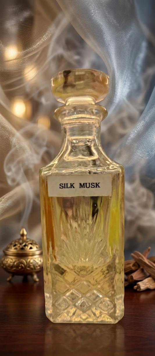 Gold bottle labeled 'Silk Musk' with decorative background