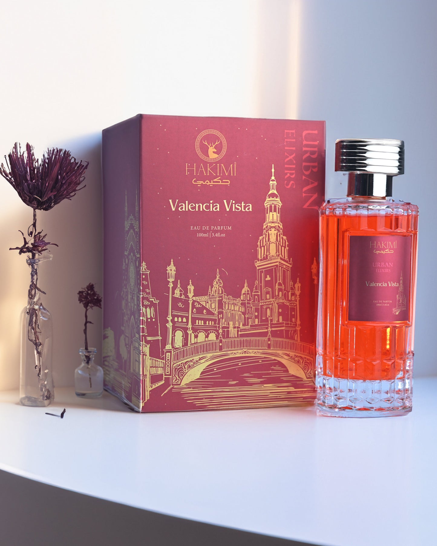 Perfume bottle and packaging on a white surface with a soft light background