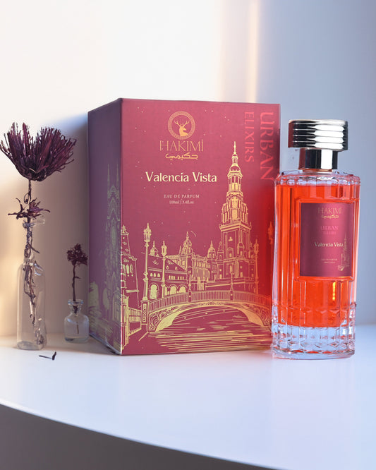 Perfume bottle and packaging on a white surface with a soft light background