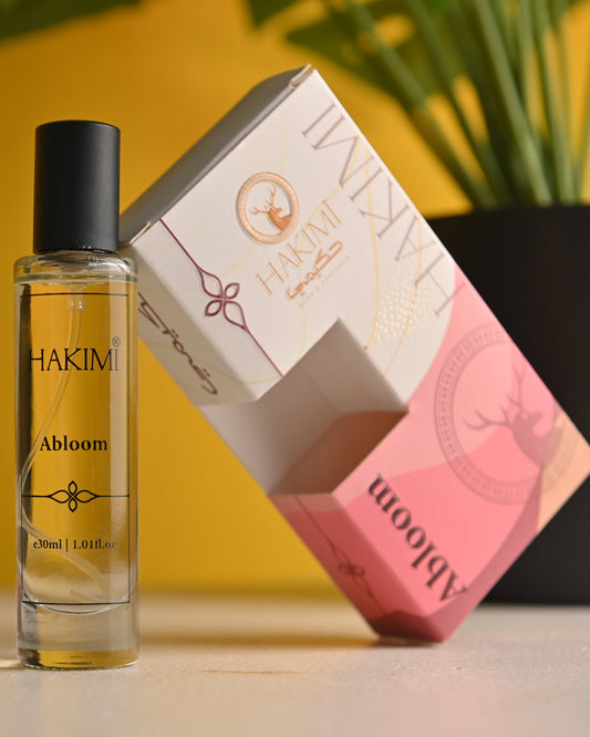 Hakimi Abloom perfume bottle and packaging on a yellow background
