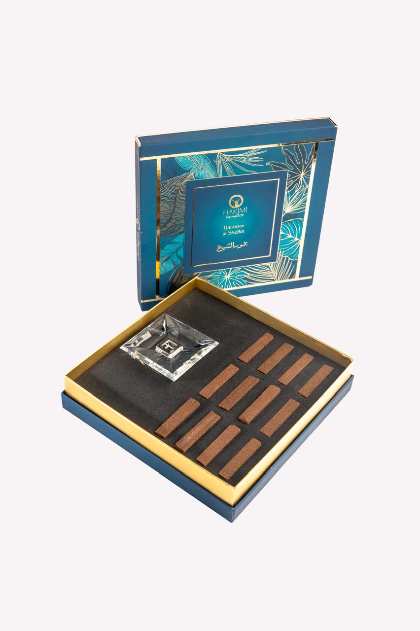 Luxury chocolate set in an elegant blue and gold box with a decorative lid.