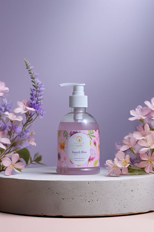 Bottle of French Rose hand soap with floral decorations on a light purple background