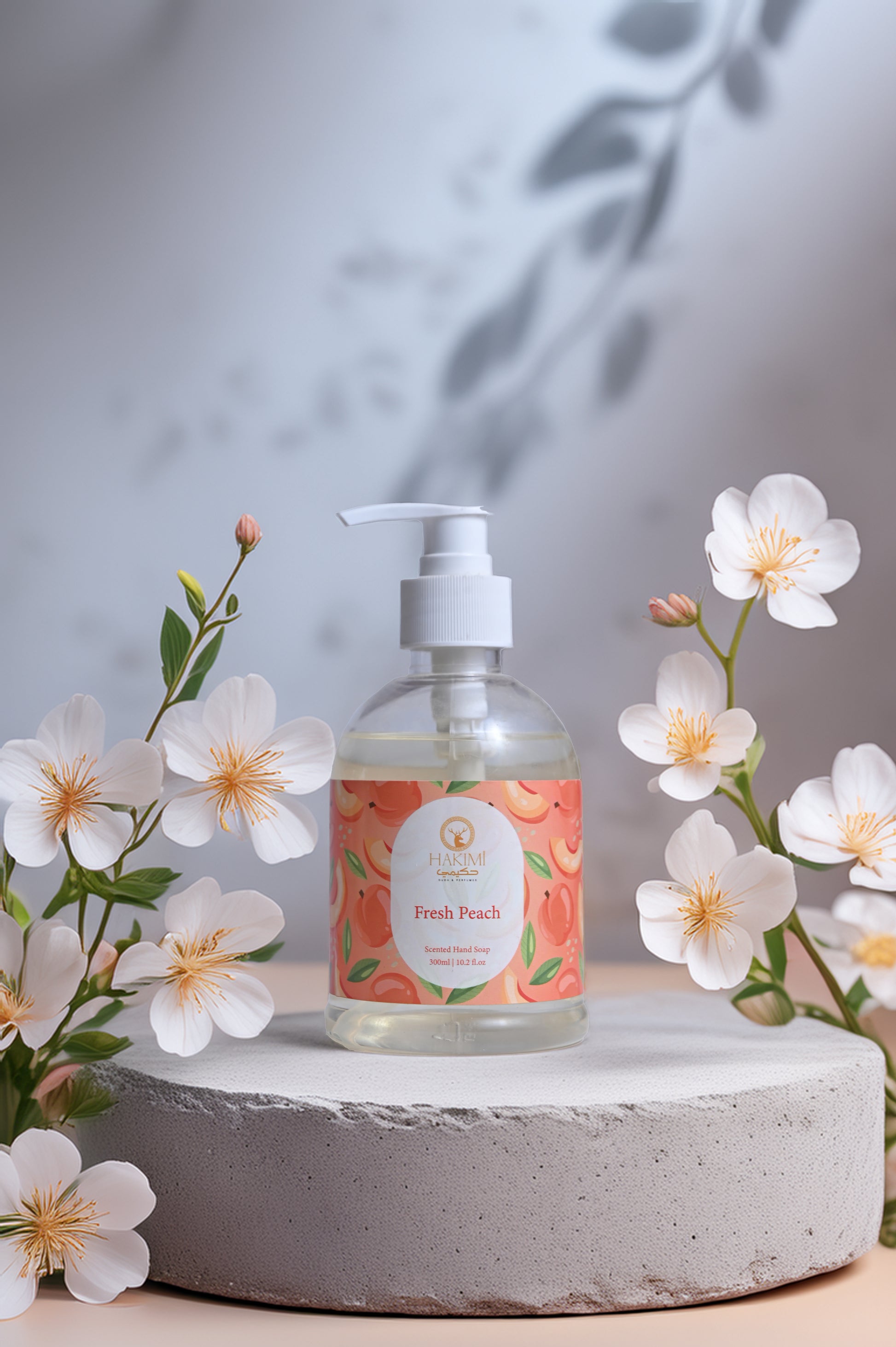Hand soap bottle with peach design on a stone surface surrounded by flowers