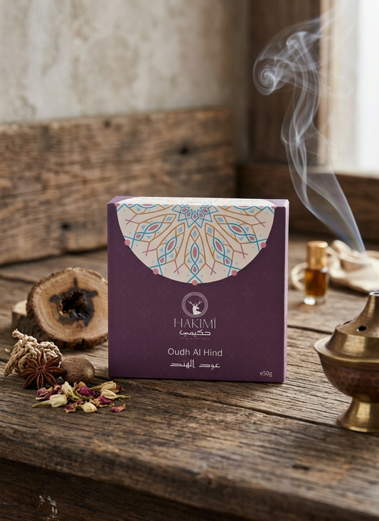 Hakimi Oudh Al Hind incense box on a wooden surface with smoke and incense sticks.