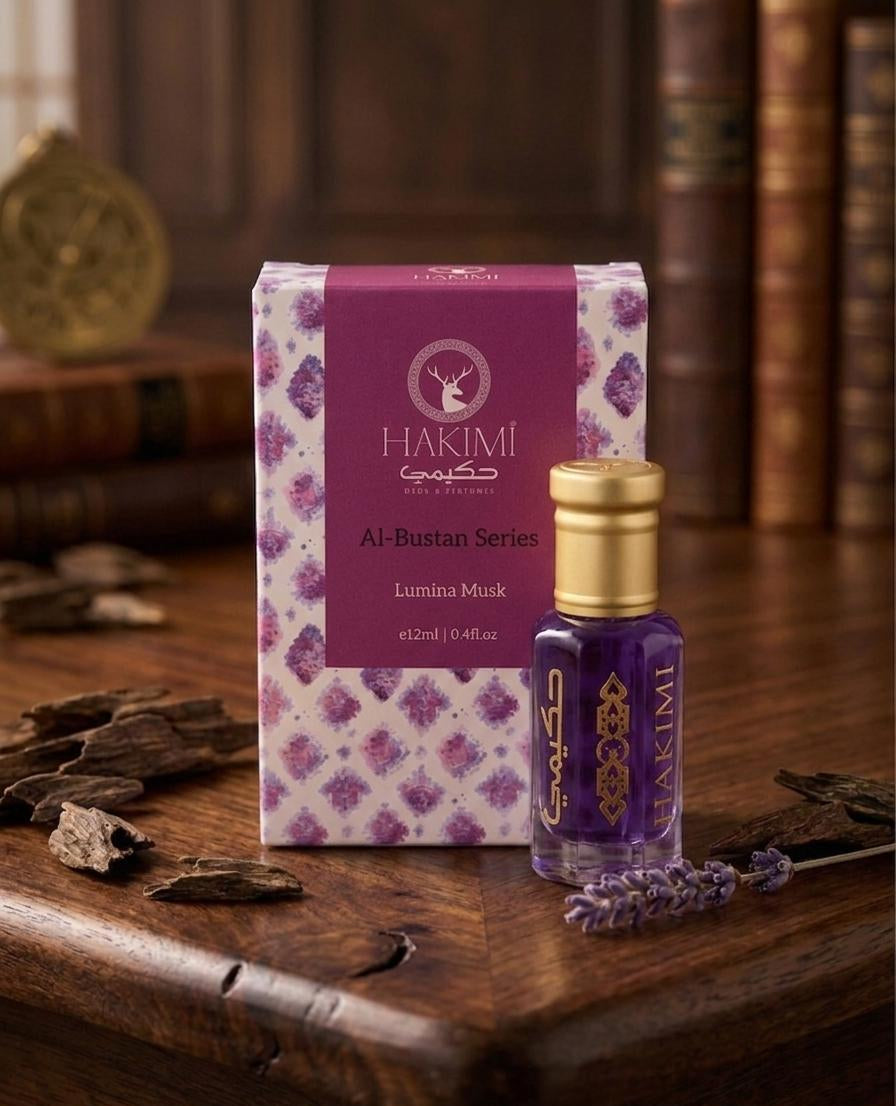 Hakimi Al-Bustan Series Lumani Musk packaging and bottle on a wooden surface with dried herbs.