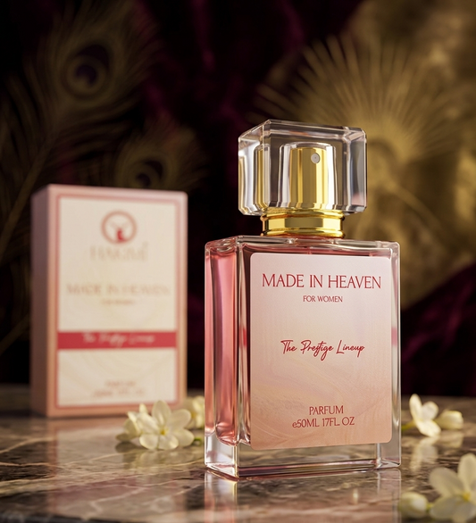 Perfume bottle labeled 'Made in Heaven' with packaging on a reflective surface.