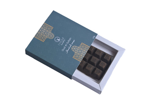 Open blue chocolate box with dark chocolate bars on a white background