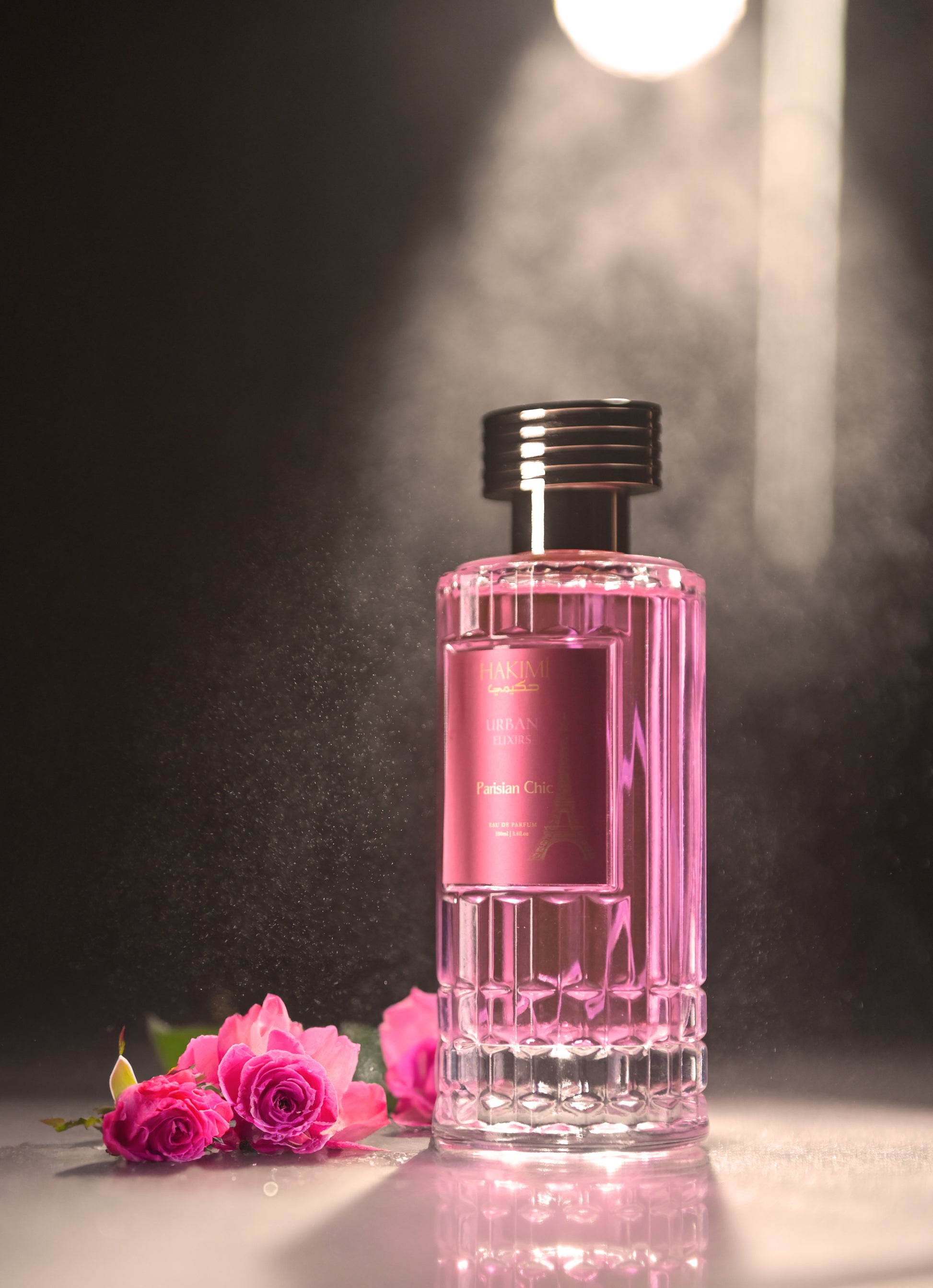 Pink perfume bottle with roses on a dark background