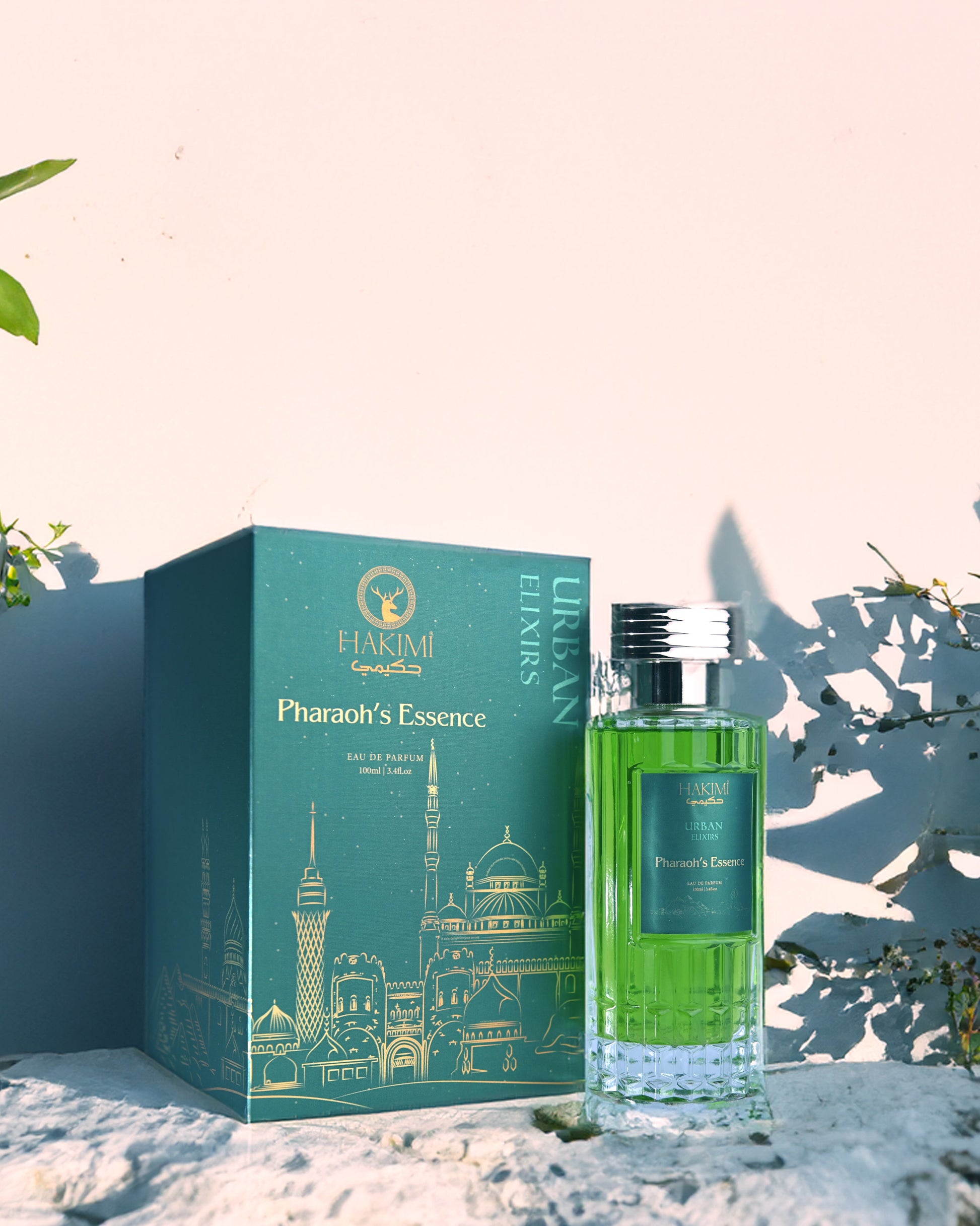 Perfume bottle and packaging with 'Pharaoh's Essence' branding on a decorative background.