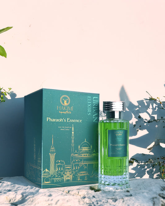Perfume bottle and packaging with 'Pharaoh's Essence' branding on a decorative background.
