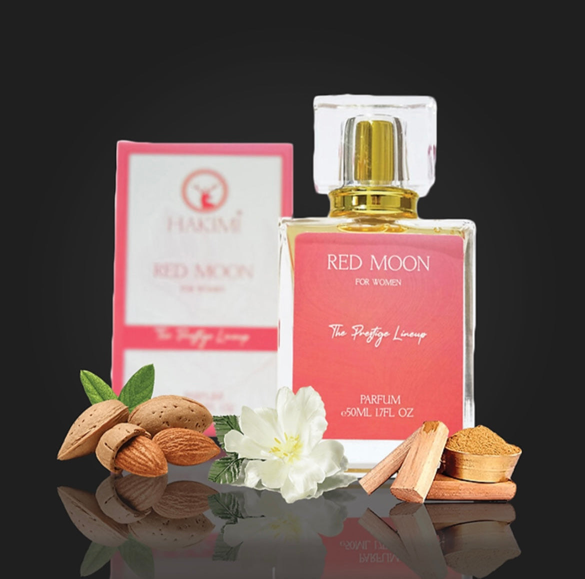 Red Moon perfume bottle with packaging and ingredients on a reflective surface