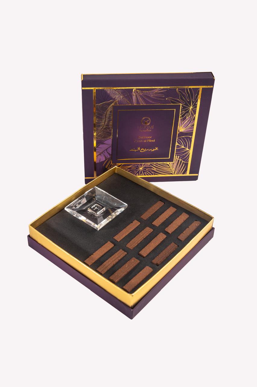 Decorative box with a crystal and wooden items on a white background