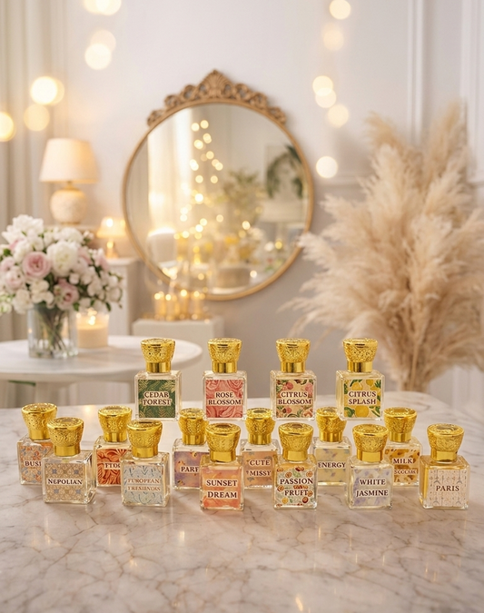 Collection of perfume bottles on a marble surface with decorative lights and flowers in the background