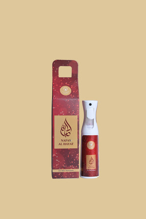Red spray bottle and packaging on a wooden surface with a white fabric background